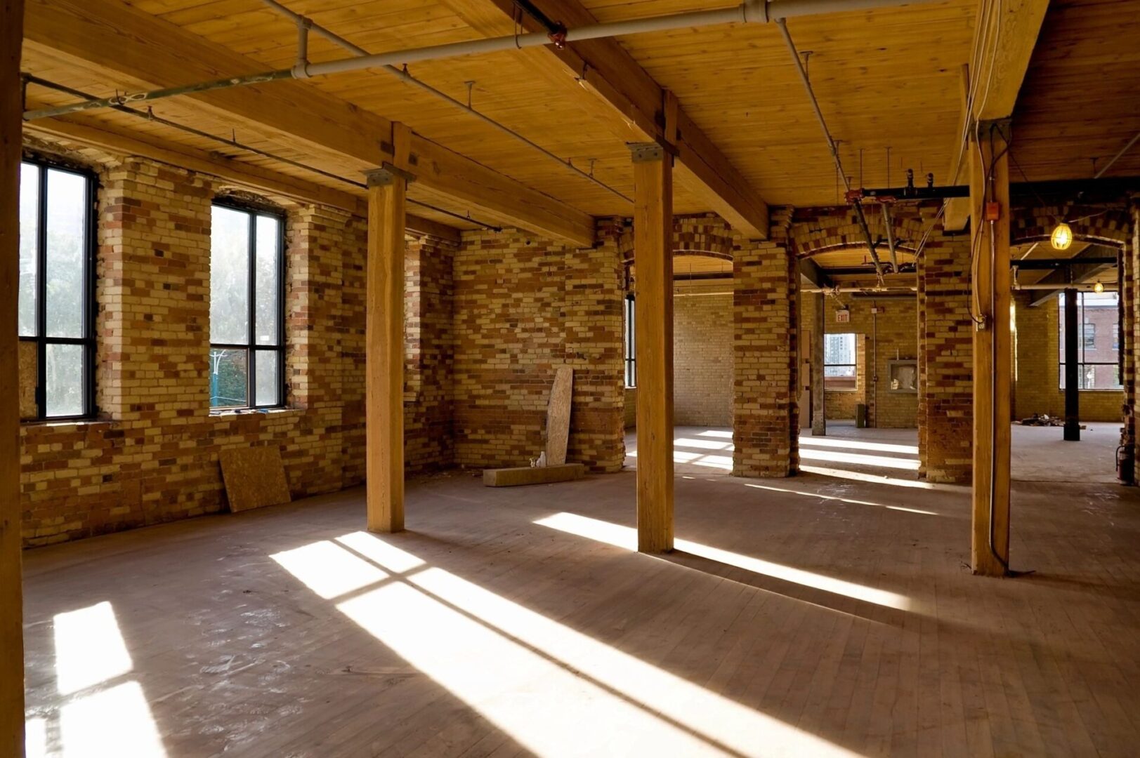 A room with many windows and wooden floors