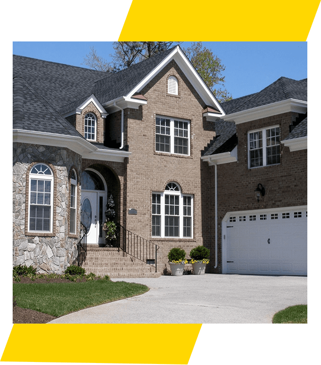 A large brick house with a white door and garage.