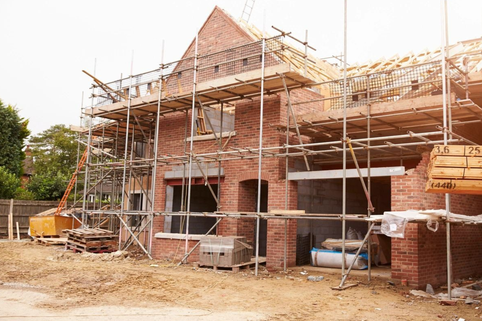 A brick building being built with scaffolding around it.